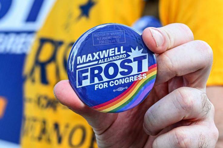 An attendee holds a button in support of Maxwell Frost