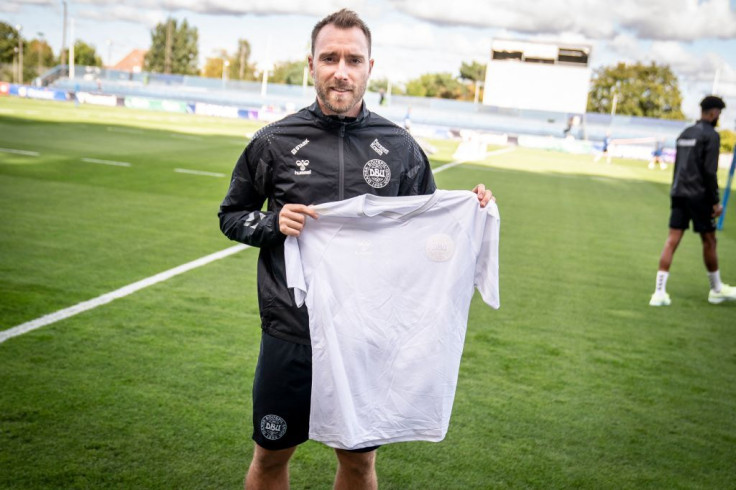 Christian Eriksen of Denmark's national football team wears a black jersey and presents the team's new white away jersey ahead of the upcoming FIFA 2022 Football World Cup 