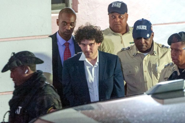 FTX founder Sam Bankman-Fried is led away handcuffed by police in Nassau