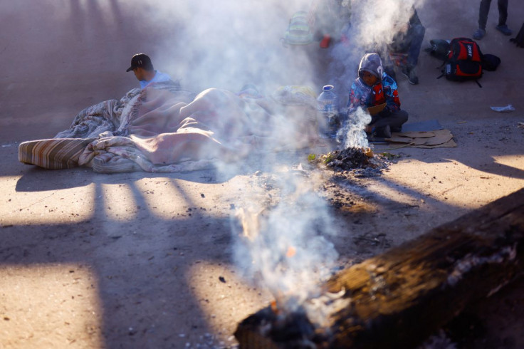 Asylum-seeking migrants rest near the Rio Bravo river, in Ciudad Juarez