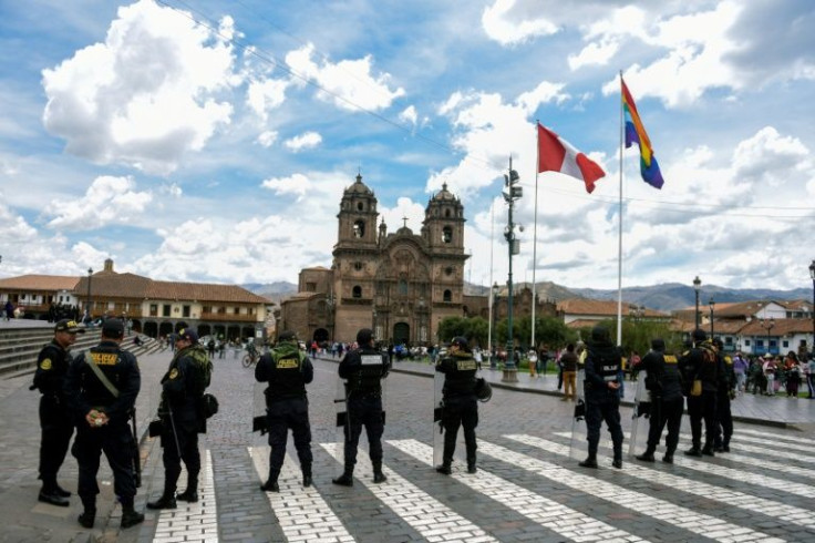 Riot police stand guard at the Plaza de Armas in Cusco, Peru