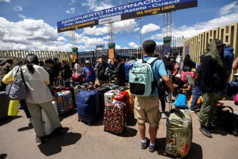 Travelers queue outside the newly reopened airport in the Peruvian city of Cusco 