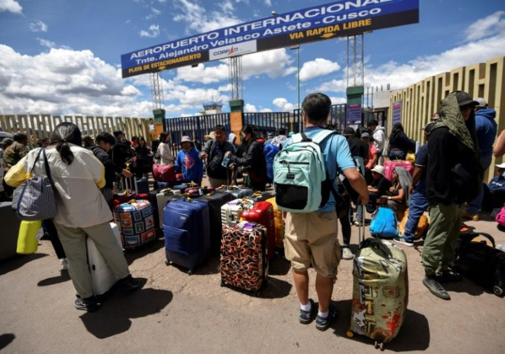 Travelers queue outside the newly reopened airport in the Peruvian city of Cusco 