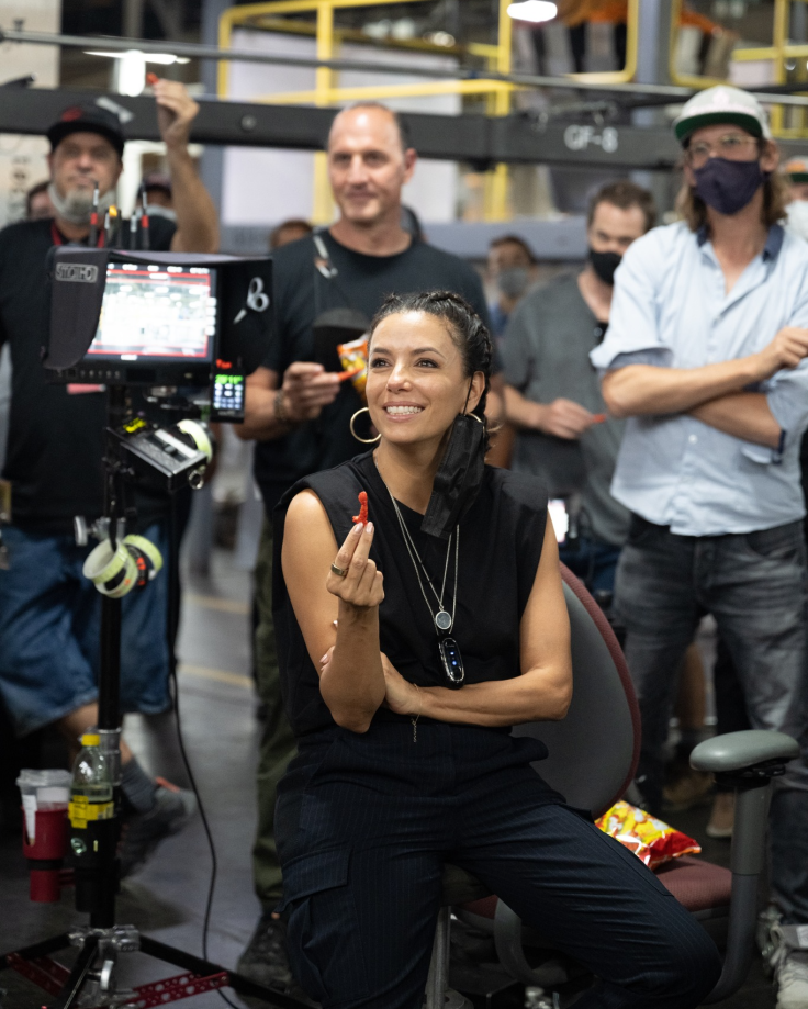 Eva Longoria posing with a hot Cheeto