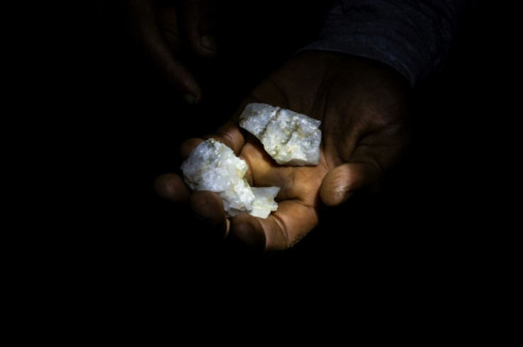 A Venezuelan miner shows rocks