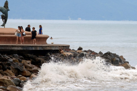 Tourists stroll along the seafront in Puerto Vallarta