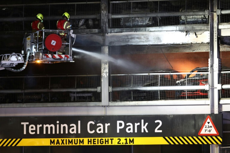 Firemen battle a fire at London's Luton Airport