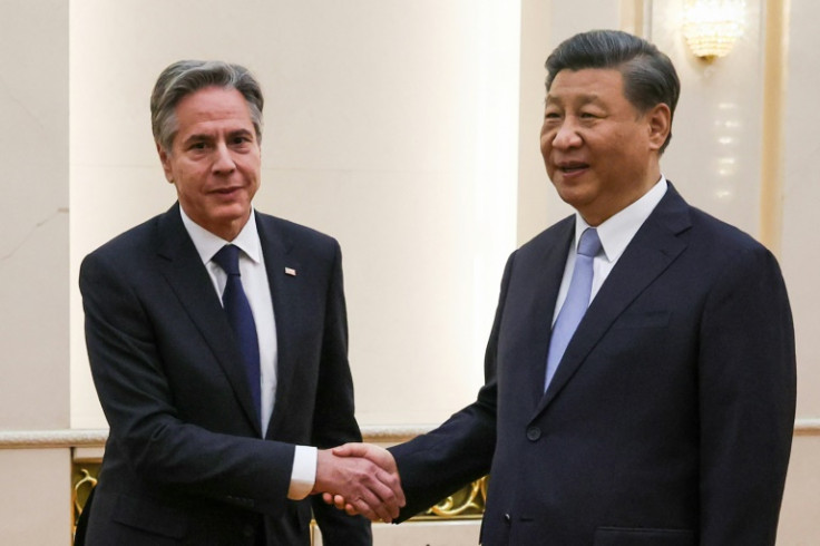 Antony Blinken shakes hands with Xi Jinping