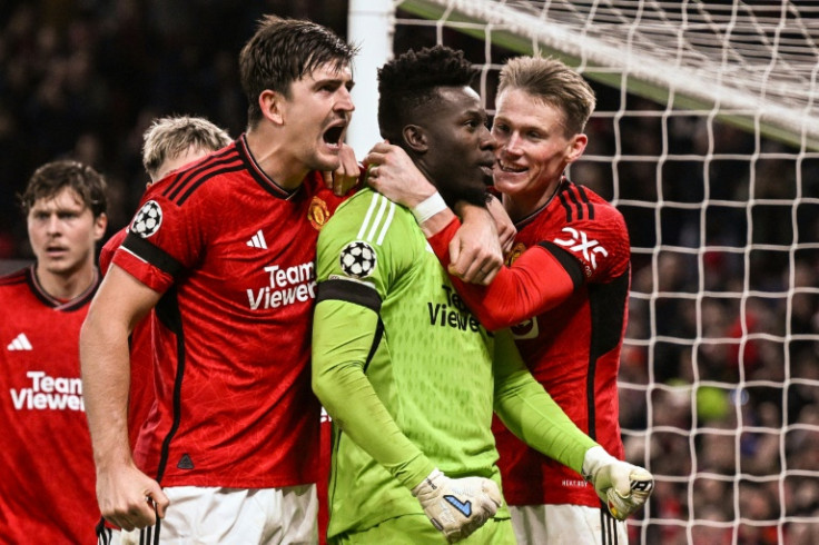 Manchester United's goal-scorer Harry Maguire celebrates with Andre Onana 