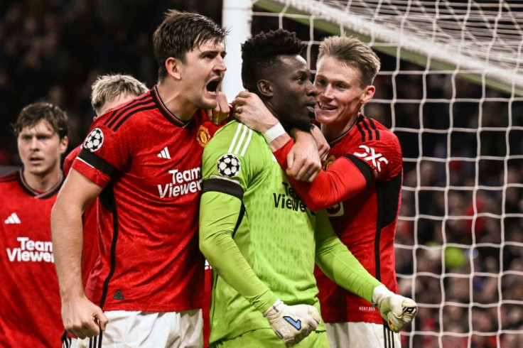 Manchester United's goal-scorer Harry Maguire celebrates with Andre Onana
