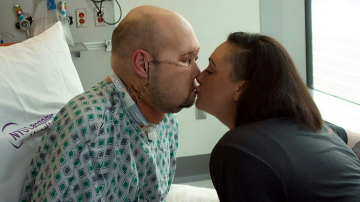 Aaron James (L) kisses his wife Meagan while he recovers 