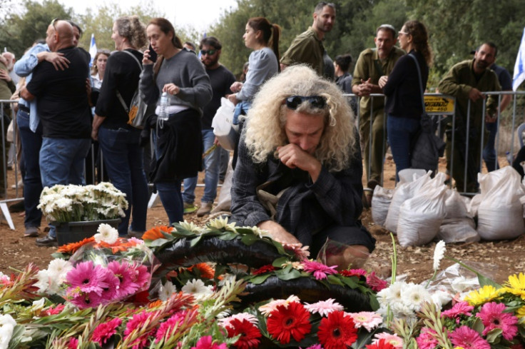 Israeli soldiers and civilians attend the funeral of Matan Meir