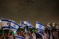 Israeli scouts wave flags as hostages return to the country