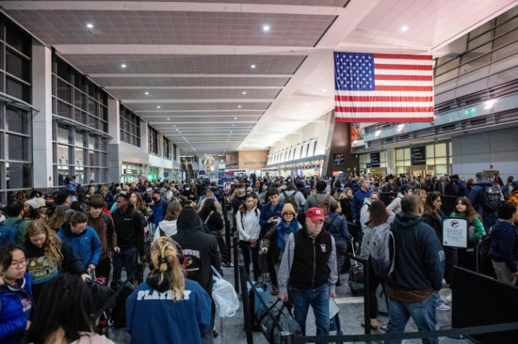 Travelers wait in the line at Boston Logan International Airport