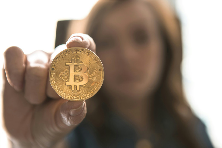 Woman holding a Bitcoin token