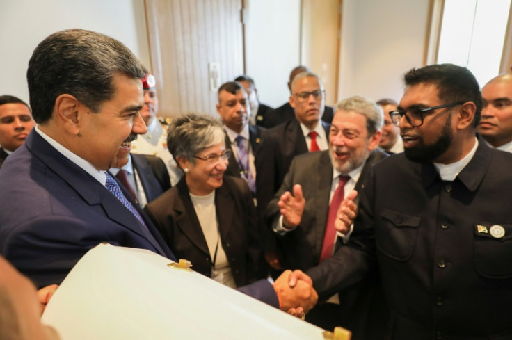 In this photo provided by the Venezuelan government, President Nicolas Maduro (L) shakes hands with Guyanese President Irfaan Ali (R), during a meeting in St. Vincent and the Grenadines on March 1, 2024