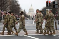US Army soldiers walk in front of the US Capitol