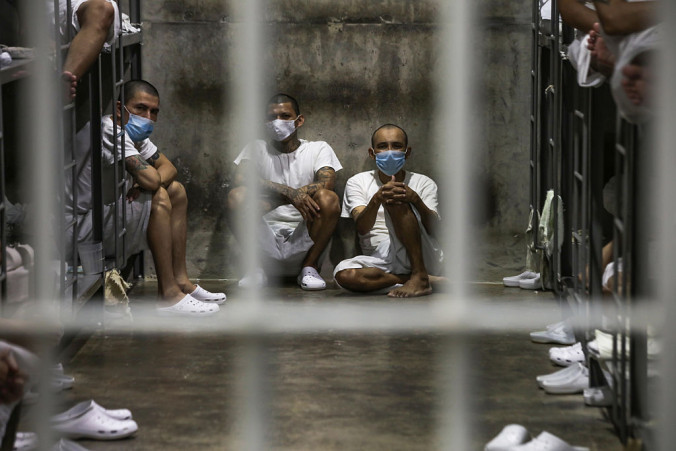Prisoners look out of their cell at CECOT prison
