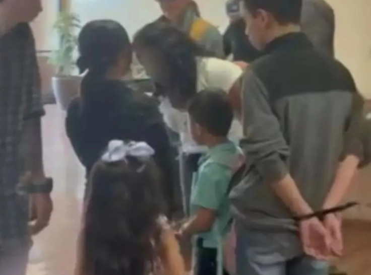 Young male immigrant appears to be detained with zip ties