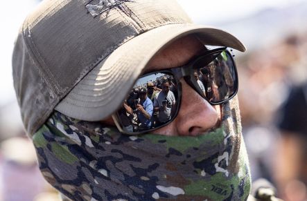 ICE official looks on at crowd during LA raid