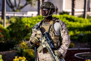 A US Marine stands guard as protesters rally during protest