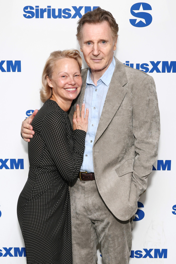 Liam Neeson and Pamela ANderson hold hand sirius Naked Gun