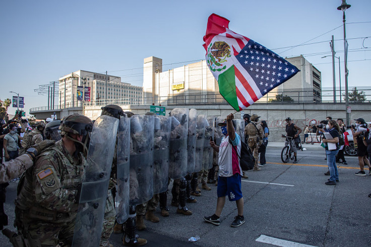 Demonstrator lifts American-Mexican flag at LA Protest Against ICE