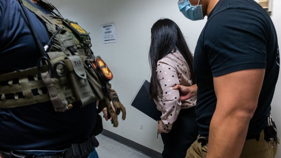 Federal agents detain a woman in immigration court