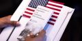 A person waits for the start of a Naturalization Ceremony 