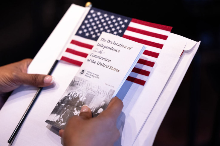 A person waits for the start of a Naturalization Ceremony