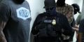 Federal agents wait outside a courtroom at New York Federal 