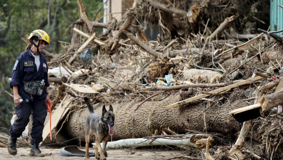 A member of the FEMA searches a flood-damaged property
