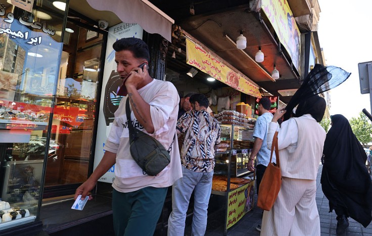 An Iranian man speaks on his mobile phone in Tehran