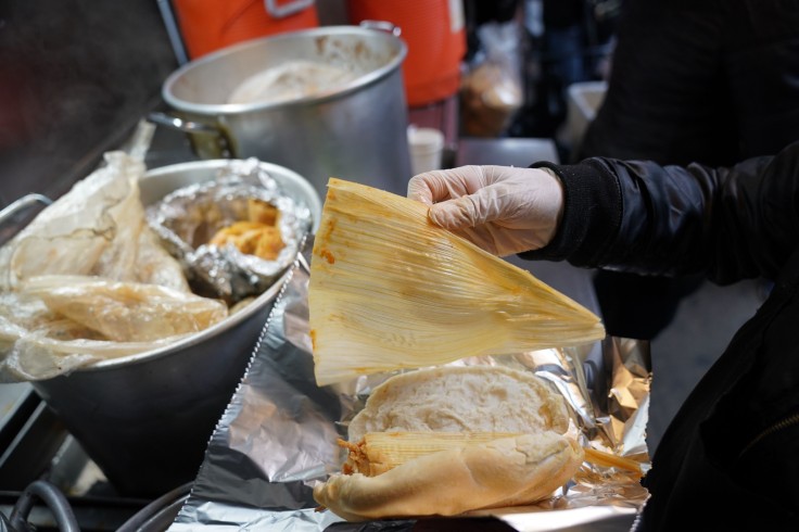 A street vendor sells tamales