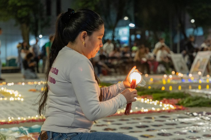 A woman lights a candle