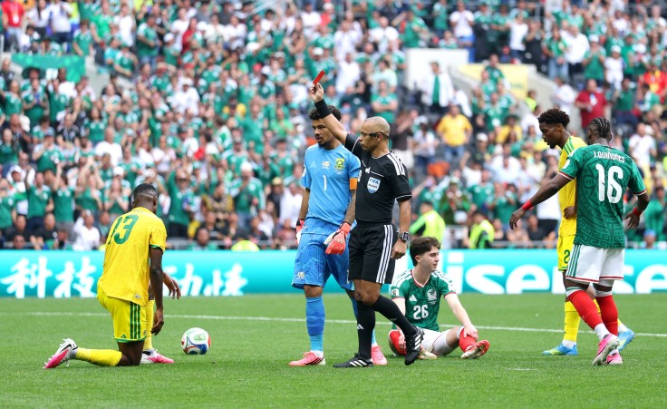 Referee Wilton Sampaio issues a red card to Sphephelo Sithole