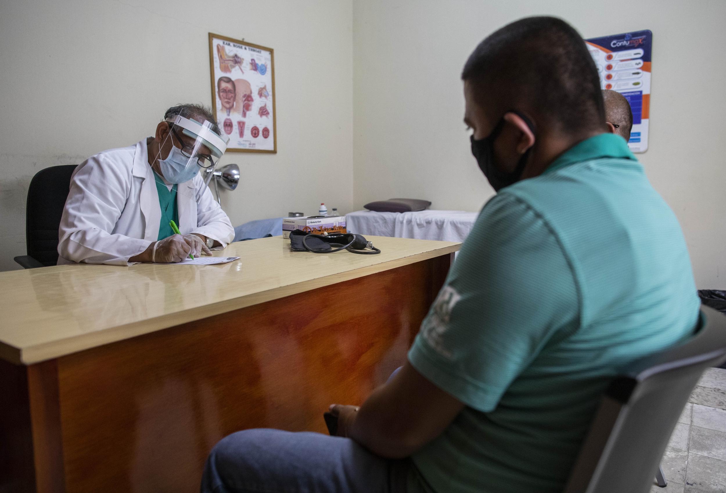 Doctor Treats Patient During Medical Consultation