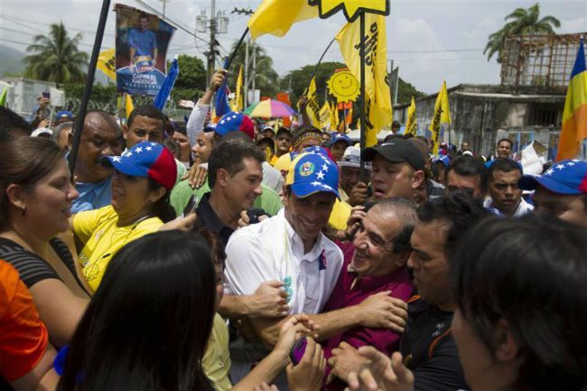 Capriles tries to outdo Chavez in display of dynamism