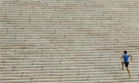 A runner ascends the steps leading up to the west side of the Lincoln Memorial in Washington October 18, 2012.