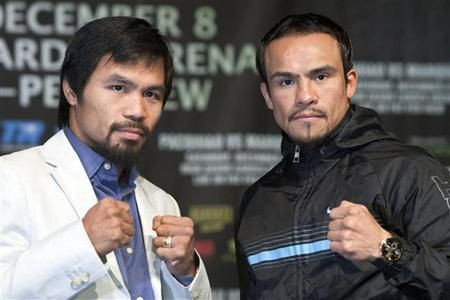Filipino boxer Manny Pacquiao (L) and Juan Manuel Marquez of Mexico pose during a news conference at the MGM Grand in Las Vegas, Nevada December 5, 2012. Pacquiao and Marquez will fight for a fourth time in a welterweight bout at the MGM Grand Garden Aren